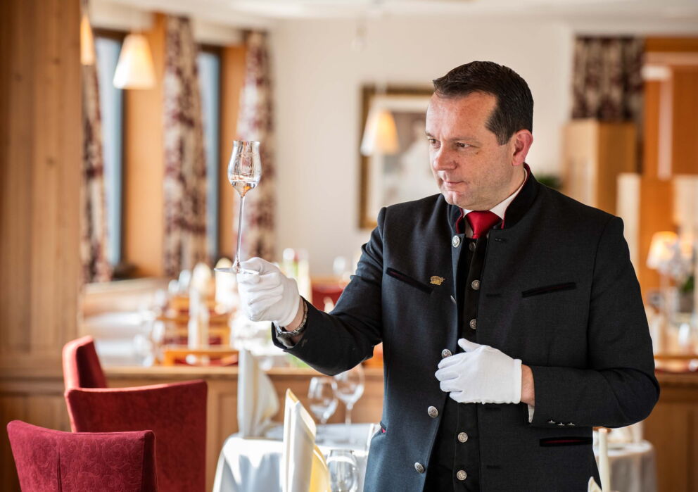 Chef de Rang with a glass of wine at the Weissen Rössl
