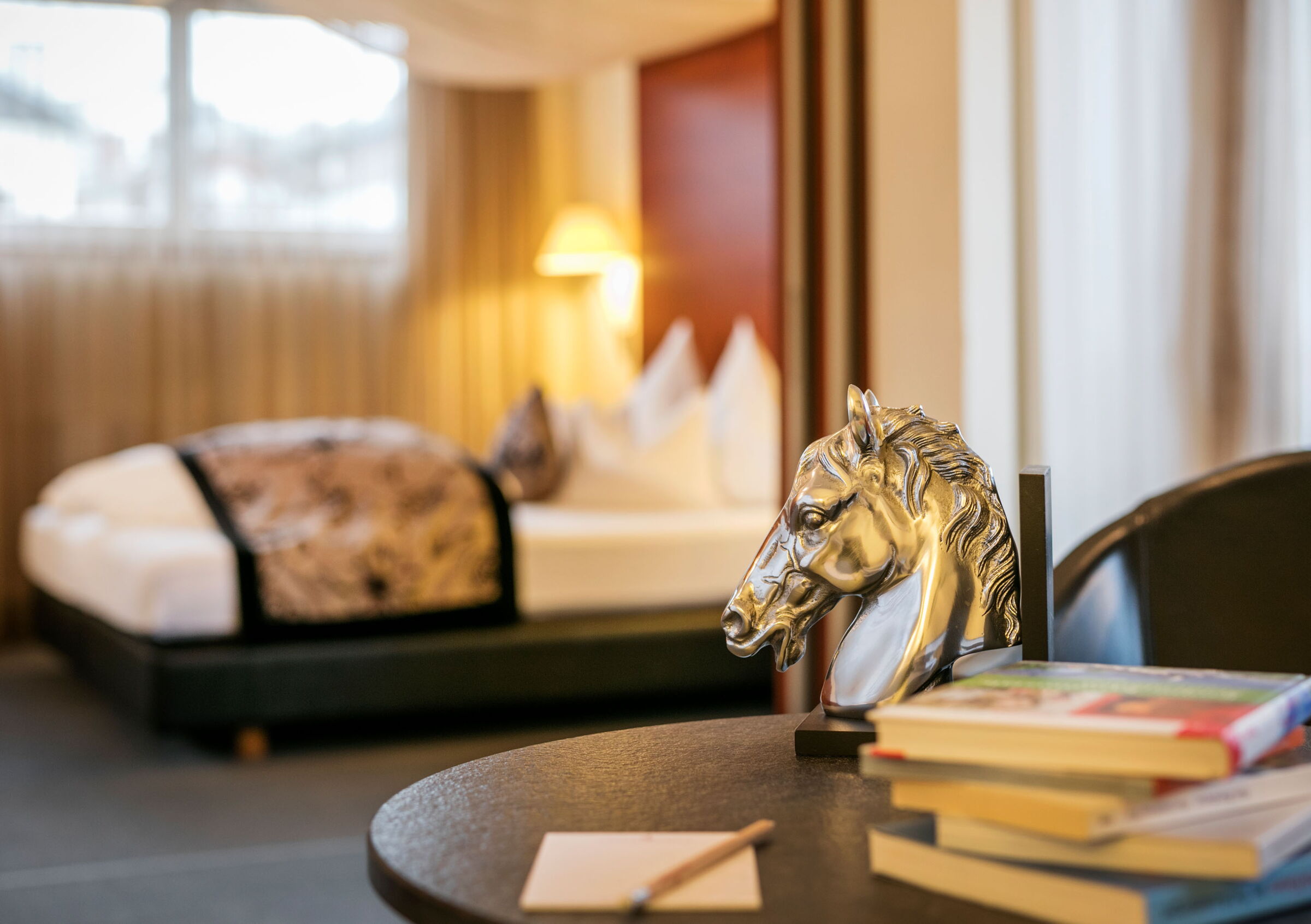 A figure of a golden horse on a side table