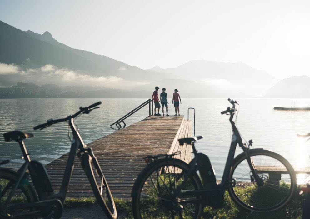 Cyclists taking a break at a jetty on the Wolfgangsee lake