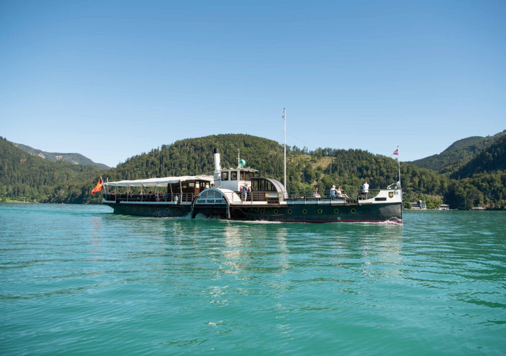 Large lake boat in the middle of the shimmering turquoise Wolfgangsee lake