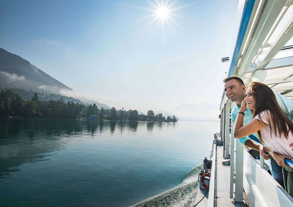 A couple on a large lake boat at Wolfgangsee in the Salzkammergut region