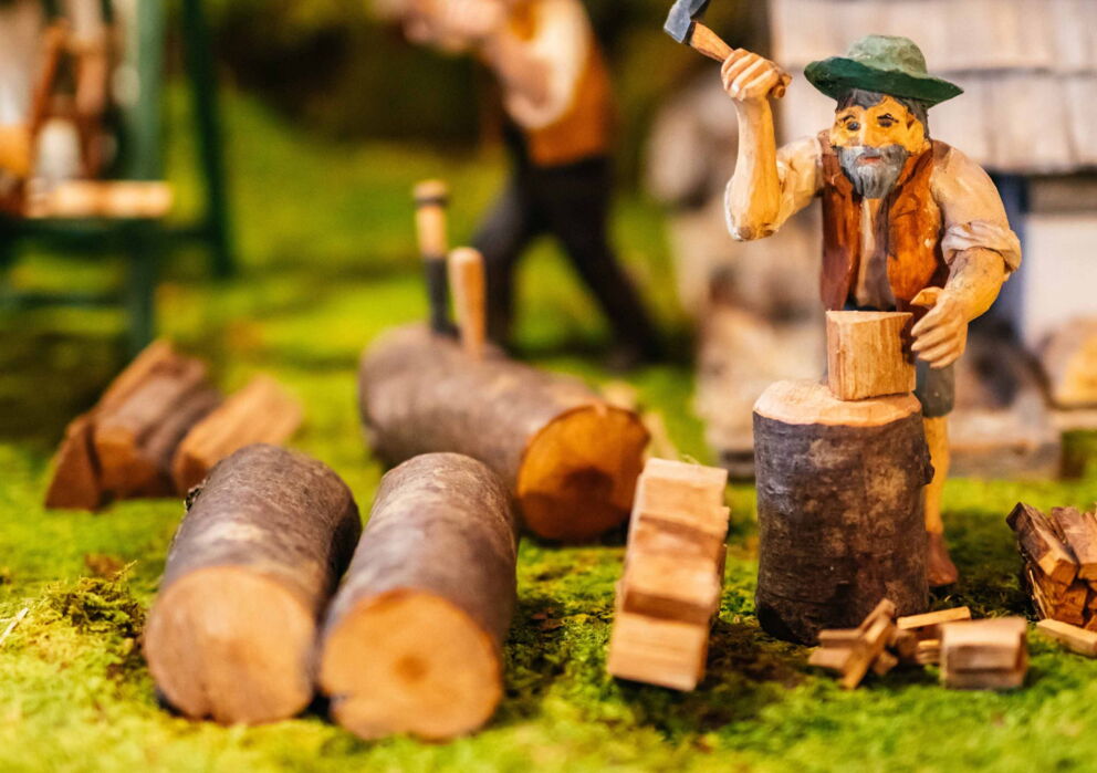 Eine Nahaufnahme einer holz grippe, eine Figur hackt holz.