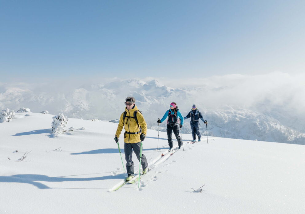 Ski tourers in snowy mountain landscape in Salzkammergut