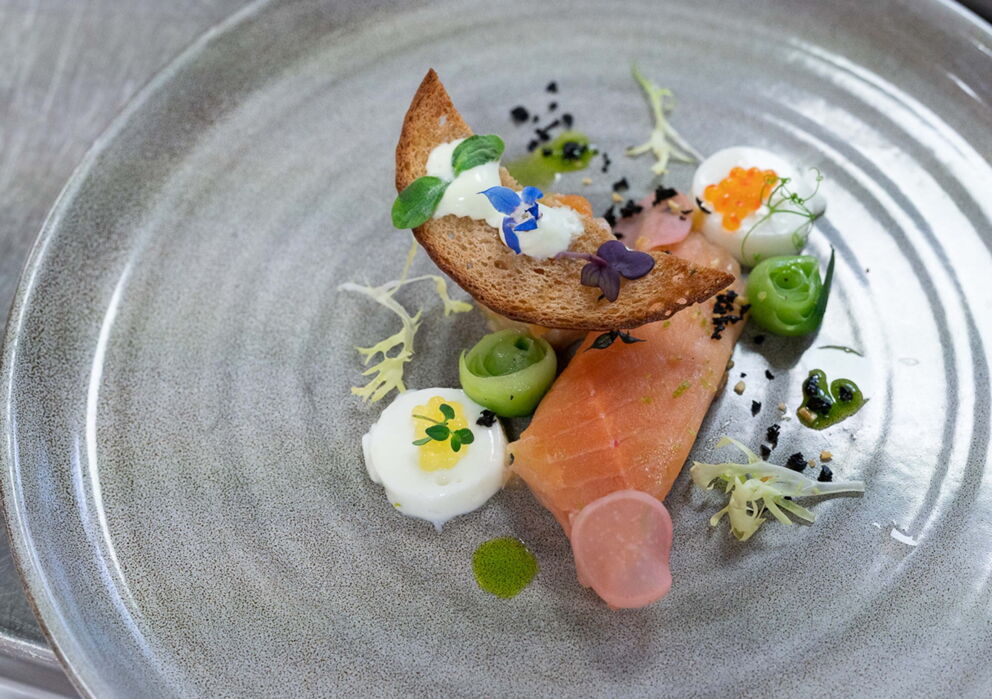 Salmon decorated with bread on a glass plate